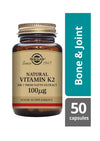 Solgar K2-vitamiini (100 mikrog) -pullo, ruskea lasi, matta kultainen kierrekorkki; "Bone & Joint", MK-7 nattouutteesta, 50 kapselia, antiikva- ja groteskiteksti beigellä pohjalla