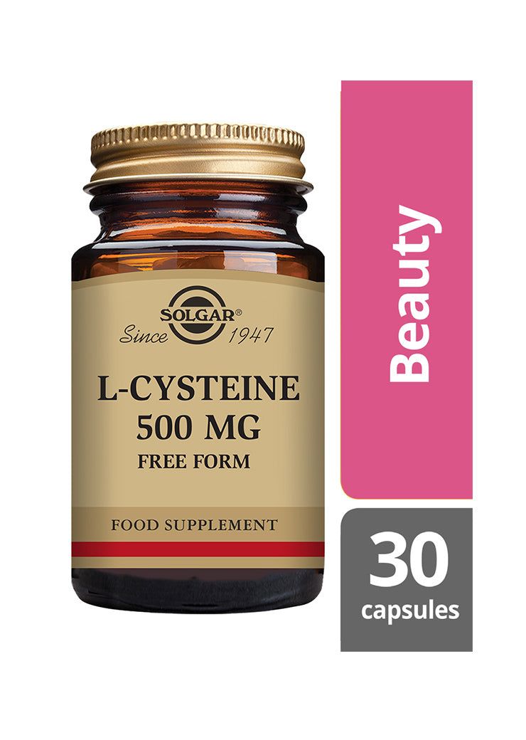 Solgar L-Kysteiini -pullo, ruskea lasi, kiiltävä kultainen kierrekorkki; musta-kultainen antiikva- ja groteskiteksti, "500 mg Free Form", vaaleanpunainen "Beauty"-laatikko ja harmaa "30 capsules"-laatikko vieressä