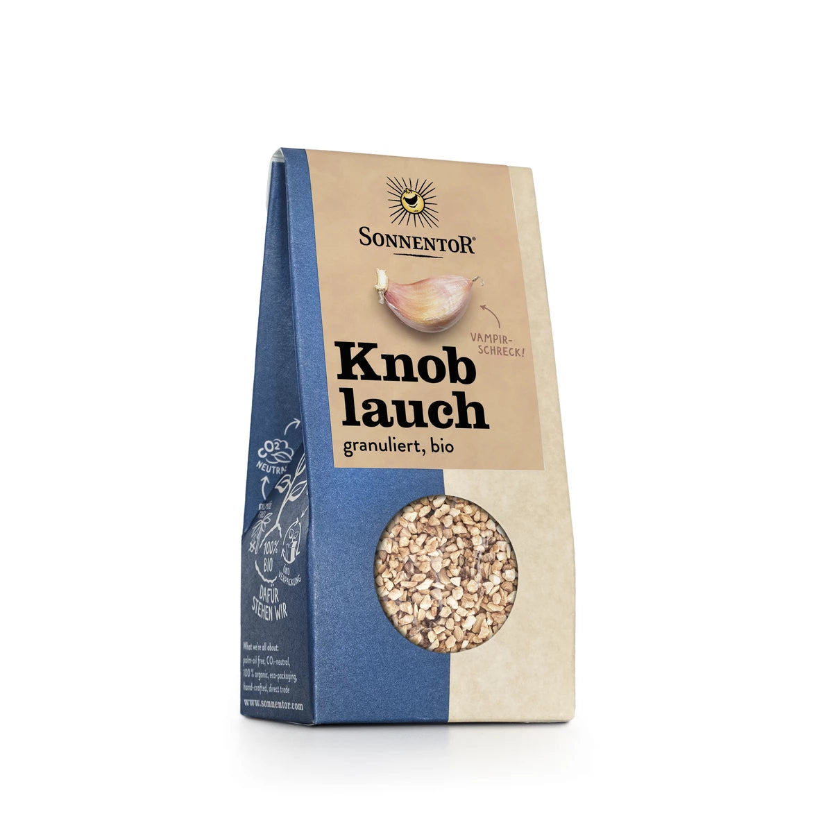 Sininen ja beige pakkaus, jossa lukee Sonnentor Knoblauch, granuliert, bio, esittää valkosipulikuvituksen ja ikkunan, joka näyttää luomurakeisen valkosipulin sisällä. Laatikko on suorakulmainen ja mattapintainen, ja siinä on pieni pyöreä leikkaus, joka näyttää sisällön. Tekstissä käytetään antiikva-typografiaa. Tuote on kuvattu pystyssä yksivärisellä valkoisella taustalla, eikä ihmisiä tai käsiä näy.