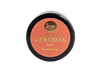 Sopo Sävyttävä Metsäbiomi Huulivoide & Poskipuna; pyöreä rasia tekstillä "Sopo Foxy Red Lip & Cheek Balm" ja maininnalla Forest Biome oranssilla taustalla, kuvattu ylhäältä; rasia pyöreä mattapinnalla, tuotenimi selkeällä groteskitypografialla; ei ihmisiä eikä käsiä näkyvissä; tausta yhtenäisen oranssi, kuva otettu ylhäältä.