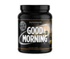 Supermass Nutrition Good Morning -herätysjuomajauhe, maku Tropical; musta lieriömäinen muovipurkki kierrekannella, mattapinta; etiketissä kaupunkisiluetti ja suuret valkoiset tekstit Good Morning super wake-up drink, all-in-one wake up blend, 500g; kuvattu vaalealla taustalla ilman ihmisiä.