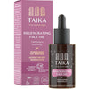 A bottle of Taika Regenerating Face Oil with dropper sits next to its pink packaging box, both featuring product details and icons highlighting Finnish extract, vegan formulation, and care for signs of aging. The bottle is cylindrical with a white label and white cap; the finish is matte. Simple sans-serif font in black; icons are small graphics on box and bottle. The background is plain white. No people or hands are present.