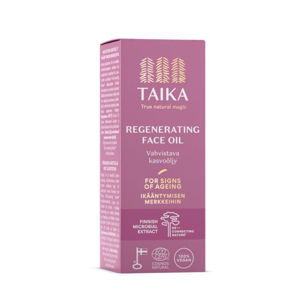 A pink rectangular box labeled “Taika Regenerating Face Oil,” matte finish, upright on a plain neutral background. Sans-serif white typography is used for the product name and benefits: Finnish microbial extract, 100% vegan ingredients, COSMOS natural certification. No people or hands in frame. A pink box of Taika Regenerating Face Oil showcases its benefits for signs of aging, featuring Finnish microbial extract, 100% vegan ingredients, and COSMOS natural certification.
