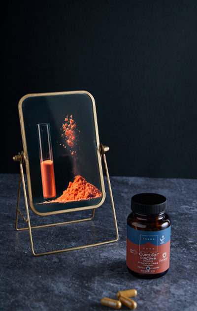 Terranova NextGen CurcuSol Curcumin Complex; kehystetty kuva oranssista jauheesta ja koeputkesta pullon vieressä tekstillä ”Curcuflame turmeric capsules”, kaksi kapselia lähellä tummalla alustalla; pullo lieriömäinen, muovia ja läpikuultamattoman valkoinen oranssilla korkilla; etiketissä lihavoitua mustaa kirjasinta brändinimelle; oranssi jauhe hienojakoista, koeputki kirkasta lasia; kuvassa ei ihmisiä tai käsiä.