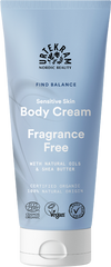 Urtekram Find Balance Fragrance Free Body Cream: sininen mattapintainen puristustuubi; etiketissä teksti "Urtekram Nordic Beauty Sensitive Skin Body Cream, Fragrance Free" valkoisella groteskikirjasimella, lisäksi maininnat luonnonöljyistä, sheavoista, luomuraaka-aineista ja vegaanisertifikaatista; tausta on neutraali ja tasaisesti valaistu, ei ihmisiä tai käsiä kuvassa.