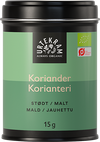 Urtekram Luomu Jauhettu Korianteri, vihreä sylinterimäinen metallitölkki mattapinnalla merkittynä "Urtekram Always Organic Koriander" usealla kielellä; pakkaus ilmoittaa 15 g jauhettua korianteria, luomusertifikaattilogot näkyvät etusivulla; huomattava groteskityppografia valkoisena ja mustana; tölkki yksin vaaleaa taustaa vasten tavanomaisessa tuotekuvassa.