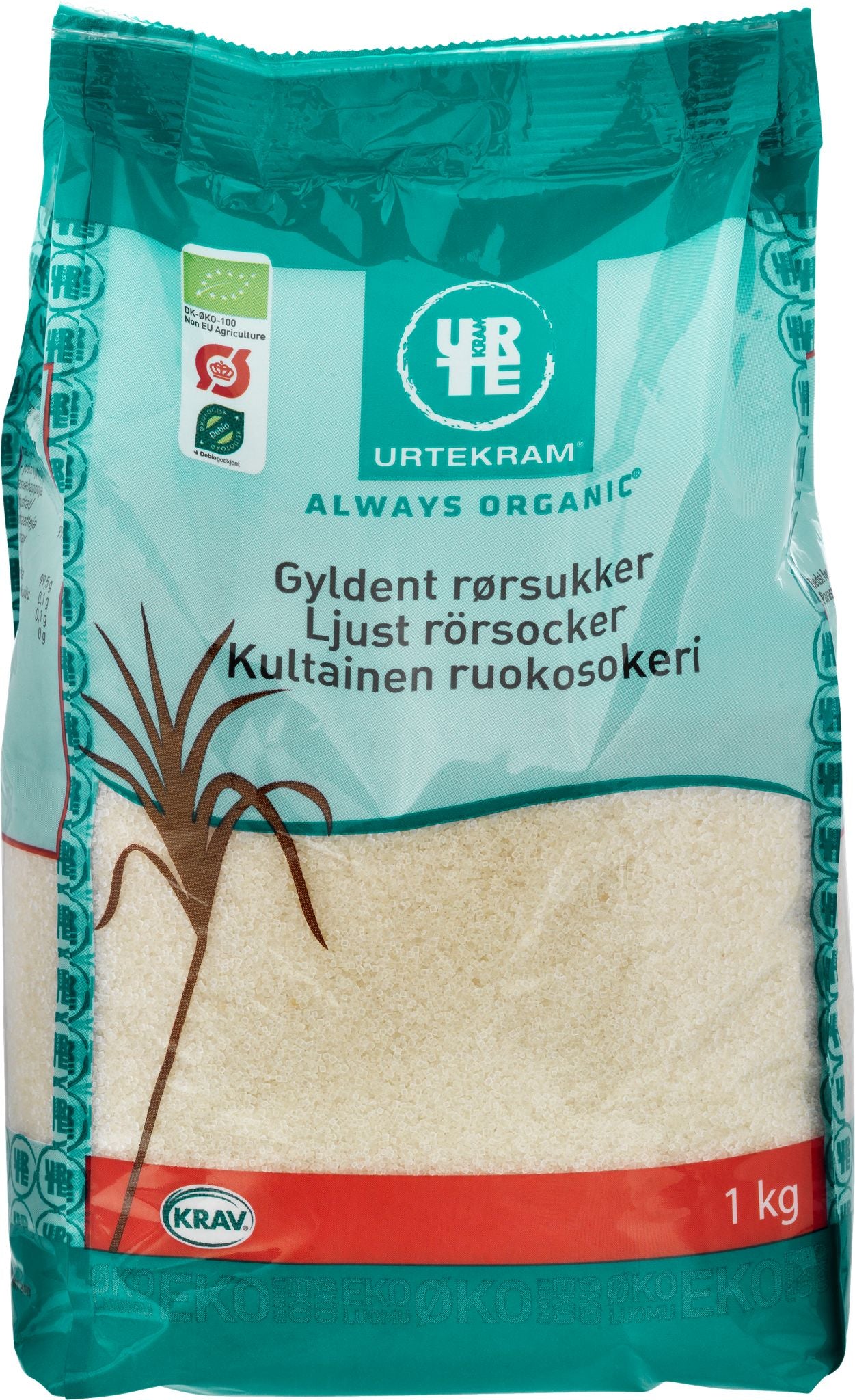 Urtekram Luomu Kultainen Ruokosokeri, 1 kg pussi luomu vaalealle ruokosokerille turkoosin ja punaisen pakkauksen kera, monikielistä tekstiä ja sokeriruokokuvitusta; pakkaus mattapintaista muovia suorakulmainen muoto, lihavoitu groteskitypografia brändinimelle; teksti sisältää painon ja tuotetiedot; kuvassa vain tuote valkoista taustaa vasten, ei ihmisiä eikä käsiä näkyvissä.