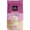 A 300g bag of Urtekram organic sesame seeds comes in purple and beige matte-finish plastic packaging. The pouch is rectangular with a flat bottom. Labels display various languages, organic certification symbols, and the bold “Urtekram” brand logo. Sans-serif fonts are used. Only product name and details are readable. Photographed against a plain white background with no people or objects present.