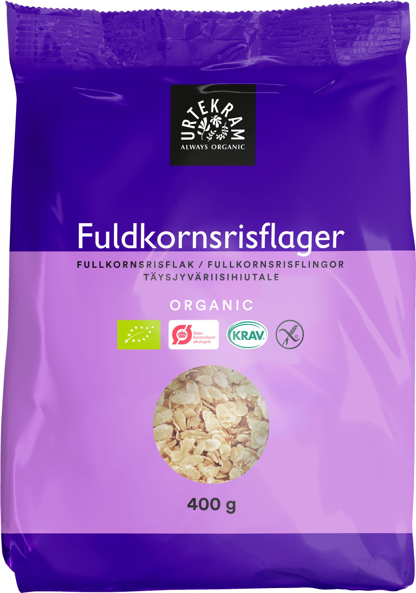Urtekram Luomu Täysjyväriisihiutale, violetti 400 g pakkaus luomutäysjyväriisihiutaleille, sertifikaattimerkinnät ja kirkas ikkuna näyttää terveelliset hiutaleet sisällä; pakkaus suorakulmainen mattapinnalla; valkoinen ja musta groteskitypografia näyttää brändinimen, tuotekuvauksen ja painon; sertifikaattilogot etusivulla; tuote kuvattu yksinkertaista taustaa vasten, ei ihmisiä eikä käsiä näkyvissä.