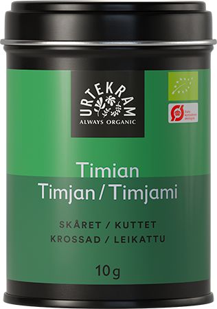 A 10g tin of Urtekram organic thyme with a green label displaying the product name and ingredients in multiple languages. The tin is cylindrical metal with a matte finish and a fitted lid. Label is green with white and black text using sans-serif fonts in different sizes. No people or hands visible. Product positioned against a plain, light background in a close-up shot.