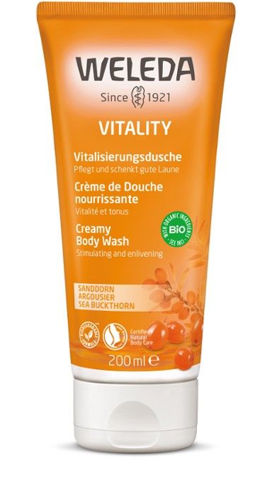An orange plastic tube labeled Weleda Vitality Creamy Body Wash, 200ml, with a semi-gloss finish and white accents. The tube is upright with a rounded cap. Label includes text in English, German, and French. Sans-serif font dominates the label. No people or objects are visible; background is simple and evenly lit. An orange tube of Weleda Vitality Creamy Body Wash, 200ml, featuring revitalizing sea buckthorn as an ingredient, with text in English, German, and French.