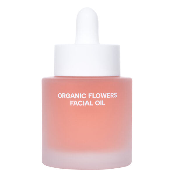 Whamisa Organic Flowers Facial Oil Deep Rich; huurrelasinen pullo valkoisella tippakorkilla, tekstillä ”ORGANIC FLOWERS FACIAL OIL”, sisältää ravitsevaa vaaleanpunaista nestettä; lieriömäinen muoto sileällä mattapinnalla; etiketissä yksinkertaista mustaa versaaligroteskitekstiä; tuote keskitettynä vaalealle tasaiselle taustalle, kuvattu tasaisessa valaistuksessa; ei ihmisiä tai käsiä.