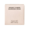 Whamisa Organic Flowers Nourishing Cream; beige rasia tekstillä ”ORGANIC FLOWERS NOURISHING CREAM”, alla teksti ”Organic 95%” ja ”50ml / 1.6 fl. oz.”; rasia suorakaiteen muotoinen mattapinnalla, oikeassa reunassa pieniä kohokuvioituja pisteitä; pääetiketti versaalikirjaimin; ei ihmisiä tai käsiä, tausta tasainen ja vaalea.