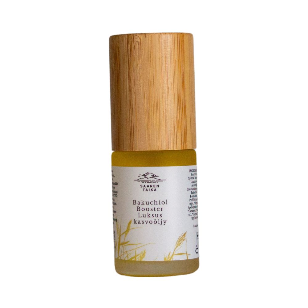 A small bottle of Saaremaa Taika Bakuchiol Booster face oil with a wooden cap and a minimalist label, featuring bakuchiol, stands upright on a white background. The bottle is cylindrical and transparent with clear liquid inside. The cap is smooth, light-colored wood. Label is matte, white, features simple black sans-serif text. No people or hands present in the image. The shot uses even overhead lighting for soft shadows.