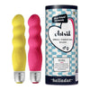 Belladot Astrid Small Vibrating Dildo: kaksi aaltomaista silikonivibraattoria keltaisena ja vaaleanpunaisena mattapinnalla seisoo pystyssä sylinterimäisen pahvipakkauksen vieressä; pakkauksessa teksti "Astrid Small Vibrating Dildo by belladot" selkeällä groteskikirjasimella; pakkauksessa myös sydämenmuotoinen kuvitus; ei ihmisiä tai käsiä näkyvissä, tausta on neutraali.