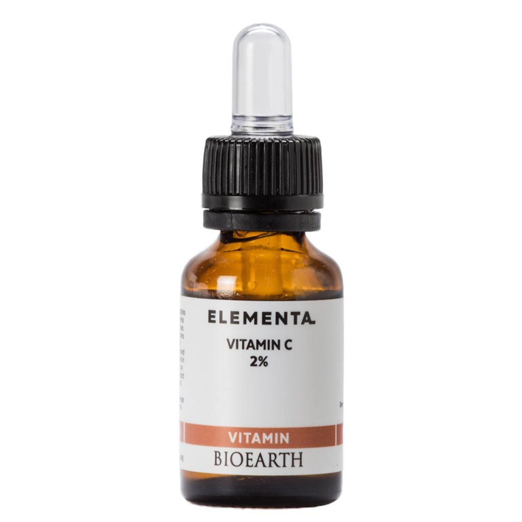 Amber glass dropper bottle labeled Elementa Vitamin C 2% by Bioearth, featuring a black dropper cap and a white label with orange and black text. Rectangular white label with sans-serif typography. Glossy bottle surface. No people present. Neutral background, studio-style product shot. This Elementa formula is designed for easy application and precise dosing.