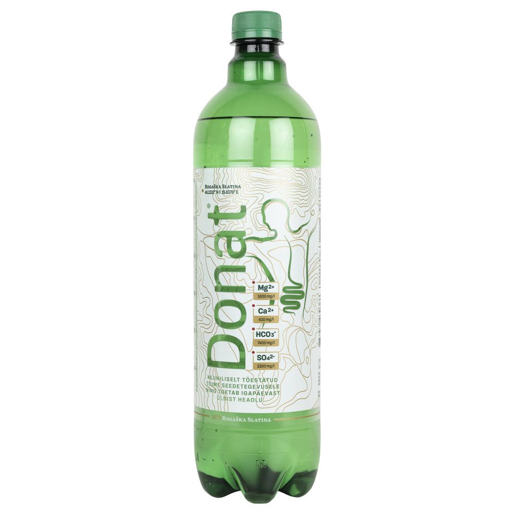 A green plastic bottle of Donat Mg mineral water with a white and gold label. The bottle is cylindrical with a glossy surface. The label includes printed mineral content details, a stylized digestive system graphic, and the brand name in bold lettering. No people or hands are present; background is plain and neutral. A green plastic bottle of Donat Mg mineral water with a white and gold label displaying mineral content and a stylized digestive system illustration for enhanced wellness.