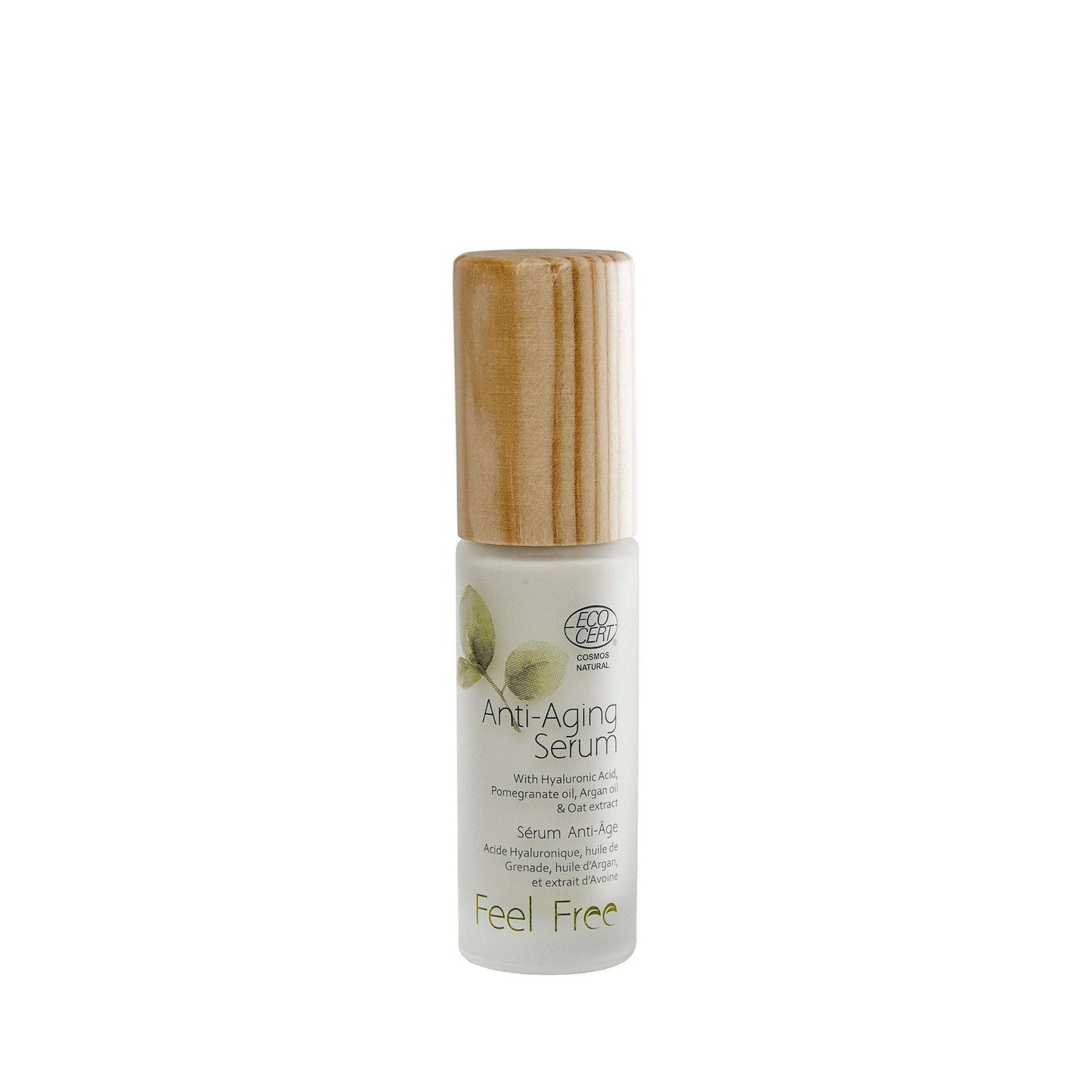 A bottle of Feel Free Anti-Aging Serum with a wooden cap and white label featuring green leaves, hyaluronic acid, and product details. The bottle is cylindrical, likely glass with a matte finish. The label features sans-serif text in green and black. No people or hands are present; the setting is a plain white background in a studio shot.