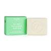 A green and white box labeled Flow Cosmetics Tea Tree Face & Body Soap Bar sits beside a light-colored, rectangular soap bar with a matte surface, featuring an embossed letter F. The packaging has minimalistic typography in bold sans-serif font. Both items are placed on a plain, light background with no visible people or props. A green and white box labeled Flow Cosmetics Tea Tree Face & Body Soap Bar sits beside a light-colored, natural soap bar embossed with an F. Ideal for oily, impure, acne-prone, and