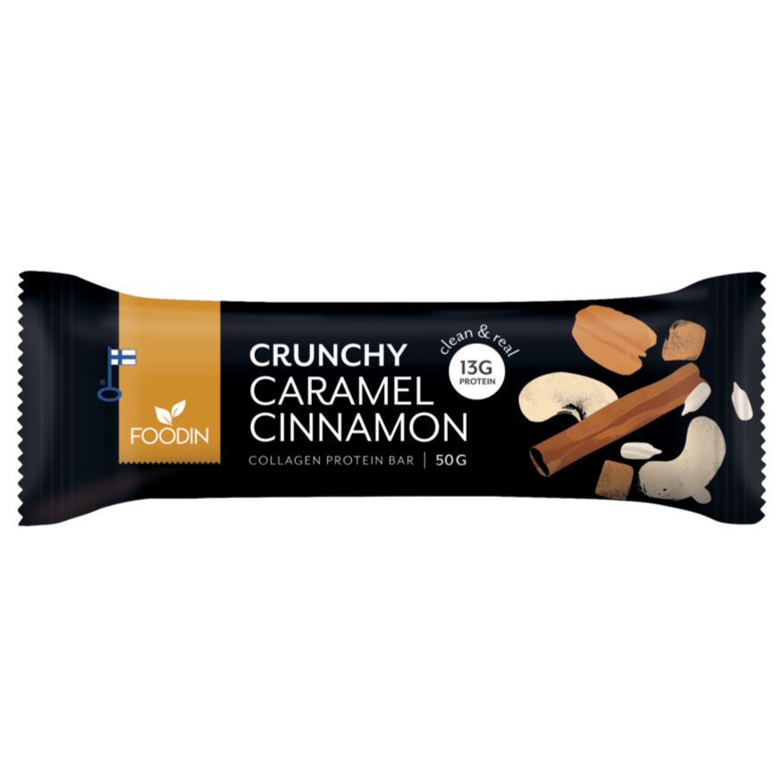 A Foodin protein bar labeled Crunchy Caramel Cinnamon, featuring images of cinnamon sticks, caramel pieces, and cashews on a sleek black wrapper. Wrapper color is black with photo-realistic graphics. Label includes 13g plant-based protein and 50g weight. Packaging has a rectangular shape with sealed ends. No people or background objects are visible in the image.