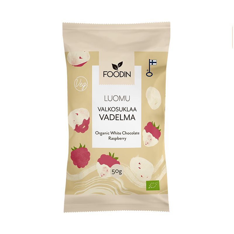 A beige bag of Foodin organic white chocolate raspberry snacks, featuring raspberry and chocolate illustrations, labeled Veg and 50g, with Finnish and EU organic logos. Matte flexible pouch with straight seams; product name in bold sans-serif font; simple graphic icons. Front-facing studio shot on a plain background. No people or objects besides the bag visible in frame.