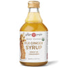 A bottle of The Ginger People Organic Fiji Ginger Syrup, 8 fl oz (237 mL), with a cylindrical transparent glass body and glossy gold metal screw cap. The front label is matte, showing a ginger root illustration and organic certification badge. Serif and bold sans-serif fonts are used for product name and details. Plain white background, centered product shot.