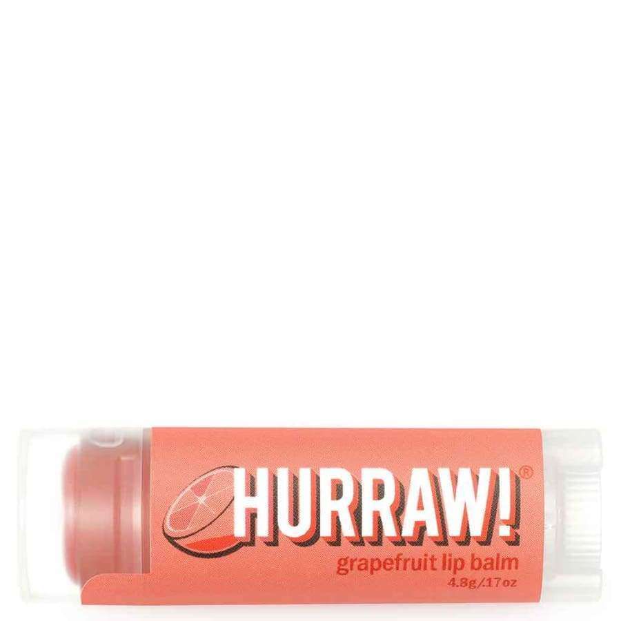 Hurraw! Huulivoide Greippi -tuubi, vaaleanpunainen-oranssi paperietiketti mattapinnalla, valkoinen lihavoitu groteskiteksti, greippiviipalekuvitus; kirkas muovituubi