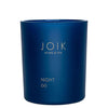 A dark blue soy candle jar labeled JOIK HOME & SPA with NIGHT and öö written below in gold text. Jar is round with straight sides and a matte finish, no visible lid or outer packaging. Label uses uppercase sans-serif font for main text, smaller type for subtext. The setting is a plain white background. No people or hands are present in the image.
