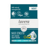 Front of a Lavera Basis Sensitiv Anti-Ageing Night Cream box, highlighting vegan, carbon-neutral, and certified organic ingredients such as coenzyme Q10 and nourishing organic jojoba. The rectangular cardboard box is light blue and white with matte finish. Sans-serif fonts in varying sizes convey product name and features. Main panel faces camera, no people or hands visible. Plain background, studio shot.