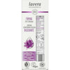 Front of Lavera Naturkosmetik Firming Eye Cream box showing product details, ingredients like hyaluronic acid and bakuchiol, certifications such as Vegan and Carbon neutral, and a purple flower image. The box is rectangular with a matte surface finish, predominantly white with purple accents. Sans-serif typography is used for all visible text. The photo is a straightforward front-facing shot with no hands or people present against a plain background.
