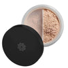 An open container of loose setting powder with a black lid, featuring two sections of finely milled beige powder for a flawless finish. The jar is circular with clear plastic sides and a matte black screw-on lid. No visible branding or text on the product. Powder is separated by an internal divider. Background is plain white, shot from above, no people or hands visible.