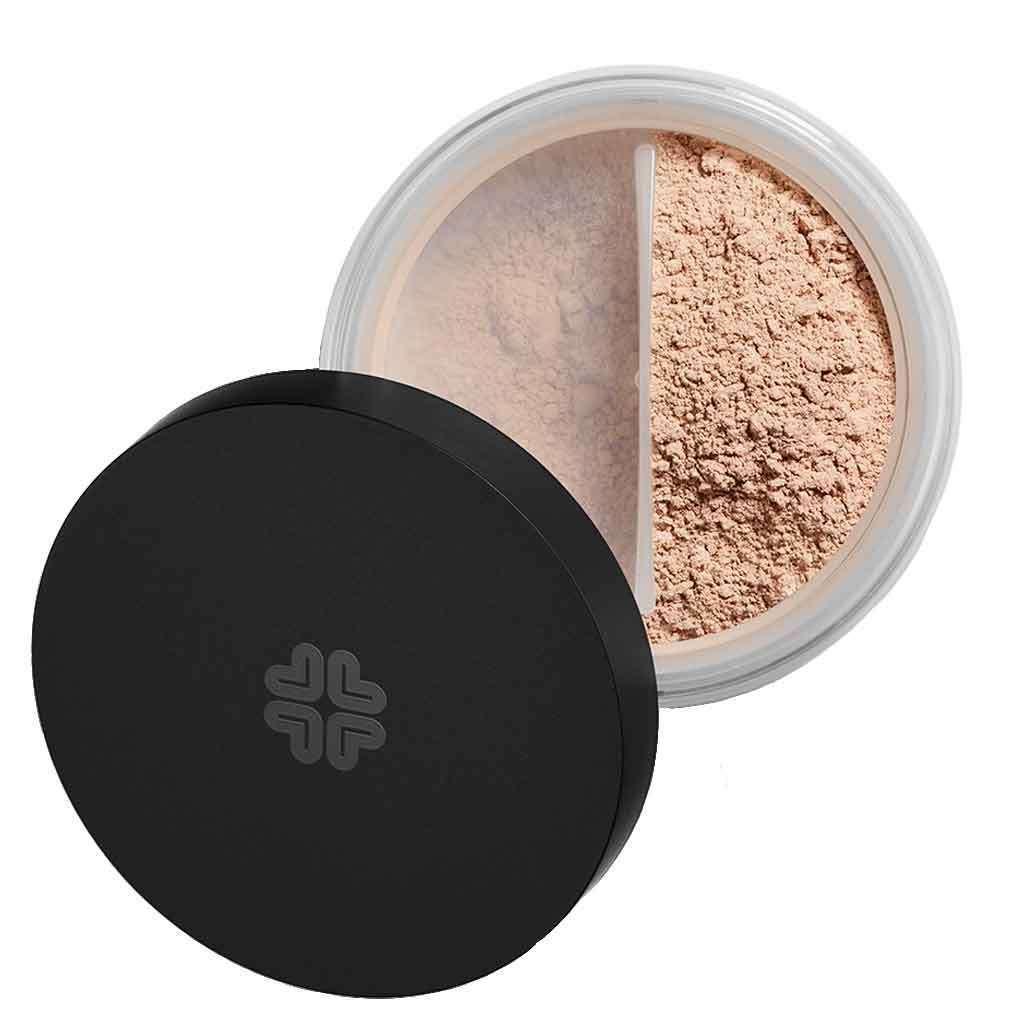 An open container of loose setting powder with a black lid, featuring two sections of finely milled beige powder for a flawless finish. The jar is circular with clear plastic sides and a matte black screw-on lid. No visible branding or text on the product. Powder is separated by an internal divider. Background is plain white, shot from above, no people or hands visible.