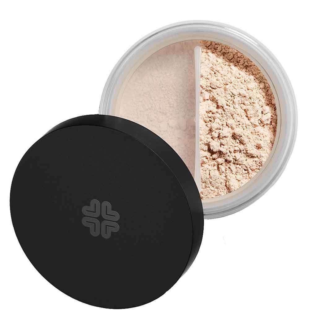 A round container of loose face powder with a black lid, partially open to reveal two sections of different shades of setting powder inside. The lid is solid black with a matte finish and no visible pattern or label text. The interior features a clear divider separating the powders. No people or hands present. Plain white background, overhead product shot.