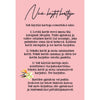 A pink card with Finnish text explaining three ways to use reflection cards, decorated with an illustration of two pastel flowers and green leaves at the bottom left corner—perfect for mindful moments or self-discovery exercises. The card has a rectangular shape, matte finish, and features sans serif black typography. No packaging or people are visible. The background is neutral and uncluttered. Photographed from above.