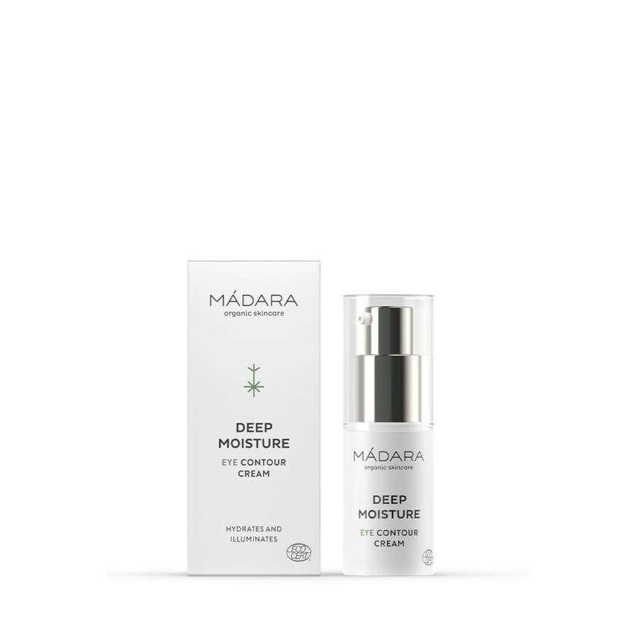 MÁDARA Deep Moisture Silmänympärysvoide -pumppupullo ja valkoinen pakkaus vierekkäin, mattapintainen; musta groteskiteksti ja pieni tyylitelty lehtikuvake