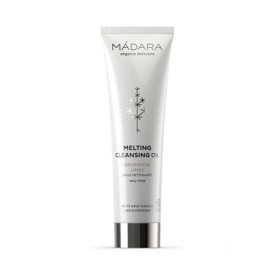 Mádara Organic Skincare Melting Cleansing Oil -puhdistusöljy; valkoinen muoviputkilo pystyssä vaalealla taustalla; putkilossa mustaa groteskitekstiä sekä pelkistetty tähtikuvio; pinta mattainen, korkkia ei näy tästä kulmasta; ei ihmisiä tai käsiä kuvassa.