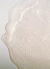 Close-up of a translucent, textured, and slightly bubbly surface that appears to be a dollop of hydrating skin-care gel or serum against a light background. Product type: gel or serum. Color: clear with possible slight tint. Material: viscous liquid. Surface finish: glossy. Shape: amorphous dollop. No packaging visible; no label text, typography, people, or hands in frame.