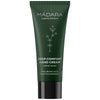A dark green tube of MÁDARA Deep Comfort Hand Cream with a matte finish, white sans-serif text, and a simple plant graphic. The front label mentions hyaluronic acid and nourishing plant polyphenols. The tube is cylindrical with a flat cap. No people or hands visible; background is plain. Shot is straightforward product photography.