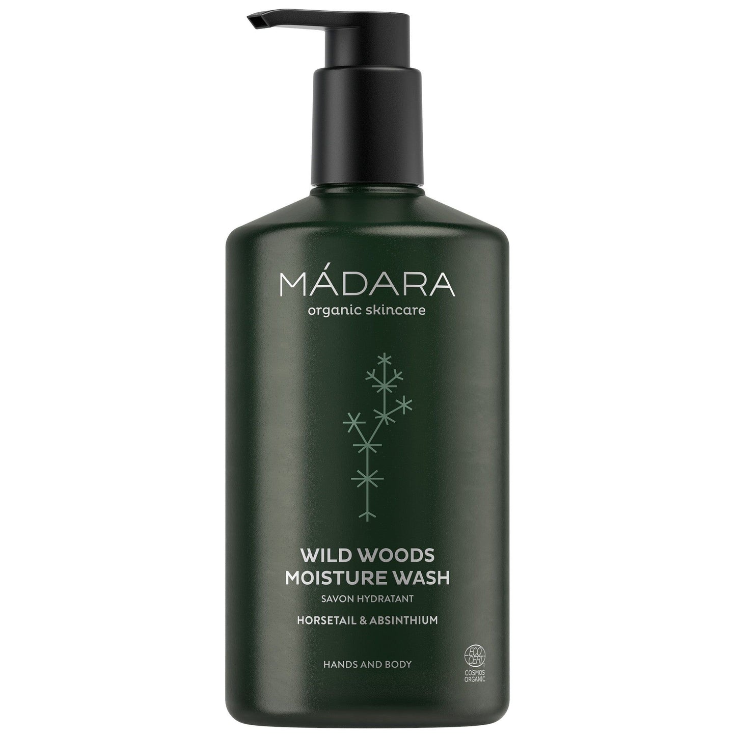 A dark green plastic bottle of MÁDARA Wild Woods Moisture Wash with a black pump dispenser. Surface is matte, bottle is cylindrical. Label shows white, sans-serif text and a small five-pointed star icon. Background is plain and neutral; no people or additional objects present. Shot is straight-on product view.