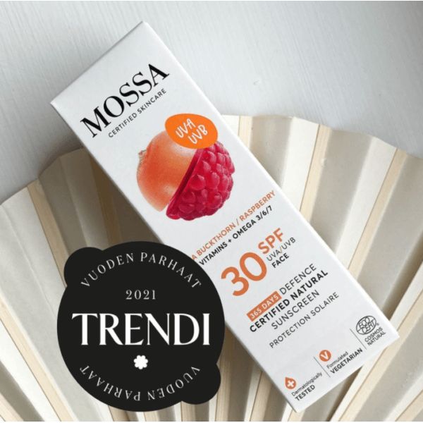 Mossa 365 Days Defence Aurinkovoide SPF 30; suorakulmainen rasia, jossa vadelma- ja tyrnikuva; mattavalkoinen pinta kiiltävin väripainatuksin, mustaa ja oranssia modernia groteskitekstiä; kuvakkeet UVA/UVB-suojasta, vitamiineista ja omega-öljyistä; kultainen "Trendi Vuoden Parhaat 2021" -mitali etusivulla; vaalea studiotausta, ei ihmisiä tai rekvisiittaa.