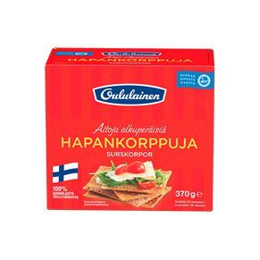 Oululainen Hapankorppuja; punainen rasia tekstillä "Oululainen HapanKorpPuJa" -näkkileipää, kuva suorakulmaisista näkkileipäviipaleista näkyvin siemenin ja lisukkein; Suomen lippu näkyvissä; mattapintainen pahvipakkaus; tuotetiedot painettu suomeksi ja ruotsiksi selkeällä groteskifontilla; rasia kuvattu yhtenäistä valkoista taustaa vasten, ei ihmisiä tai käsiä.