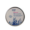 A round tin labeled “Ruusuu Merisuola deodorantti” with blue plant illustrations and Finnish text is placed on a smooth white background. The tin has a matte silver surface and shows clear sans-serif typography. No people or hands are present in the shot, which is taken from above. The product highlights the natural freshness of sea salt.
