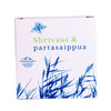 White box labeled Sheivaus & partasaippua features blue grass illustrations and a blue leaf. The SAAREN TAIKA logo appears below the text. Rectangular box with matte finish, mostly white surface, printed in bold sans-serif font. Blue botanical graphics occupy the left and top sides of the front panel. Studio background is plain white. No people or visible hands present in image.