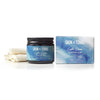 A glass jar labeled “Skin & Tonic Calm Clean Cleansing Balm” sits beside a matching rectangular box and a folded white cloth. The jar and box are both predominantly white with simple, sans-serif black typography. The background is solid white and the shot is overhead with no people or hands visible. A jar of Skin & Tonic Calm Clean Cleansing Balm with its box and a folded white cloth are beautifully displayed on a white background, highlighting the balm’s gentle, soothing formula.