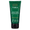 A green squeeze tube with a matte finish labeled Taika Brightening Face Scrub for all skin types, with white and yellow sans-serif text, eco and vegan symbols, and a black plastic flip-top cap. The product is photographed upright on a plain white background. No people or hands visible in the shot.