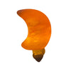 An orange, crescent moon-shaped LED night light plugged into a wall outlet, glowing softly against a white background. Night light is made of smooth plastic with a matte finish. There is no visible branding or packaging. The product is shown in close-up; no people or hands are present.
