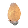 A glowing Himalayan salt lamp night light plugged into a wall outlet. The lamp features a rough, egg-shaped salt crystal emitting a soothing amber glow. The crystal has an uneven, matte finish and is mounted on a small plastic base that fits directly into the socket. No visible packaging, label text, or additional objects; indoor setting.