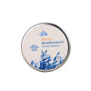 A round metal tin with a matte finish is labeled “Tyrni deodorantti” in orange and blue text, with a small bee graphic. The lid displays blue grass illustrations on a white background. The tin is photographed against a plain white backdrop. No people or hands are present. Other label details describe the product’s qualities, but only core text is legible.