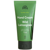 Urtekram Blown Away Wild Lemongrass Käsivoide; vihreä Urtekram Hand Cream Wild Lemongrass -tuubi, 75 ml, sertifiointilogoja ja yksinkertainen heinäkuvitus, vaalealla taustalla; tuubi lieriömäinen mattapinnalla, läppäkorkki; valkoinen groteskiteksti näyttää tuotenimen ja koon; ei ihmisiä tai käsiä kuvassa.