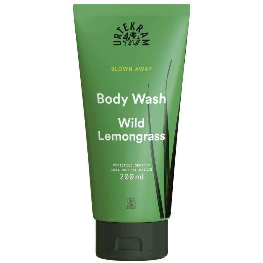 Urtekram Blown Away Wild Lemongrass Suihkusaippua; vihreä Urtekram Blown Away Body Wash Wild Lemongrass -tuubi, 200 ml; tuubi sileä mattapinnalla, lieriömäinen muoto; heinäkuvituksia alareunassa; valkoista ja keltaista tekstiä, joka listaa tuotenimen sekä ilmoittaa luomusertifioinnista ja 100-prosenttisesta luonnollisesta alkuperästä; ei ihmisiä tai käsiä; vaalea tausta, kuvattu edestä.